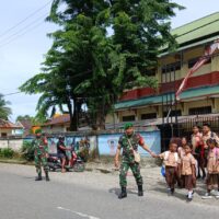 Peduli Keselamatan Anak Sekolah, Secara Rutin Babinsa Koramil Jajaran Kodim 1710/Mimika Bantu Seberangkan Jalan